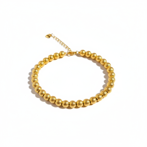 Gold bracelet on white background